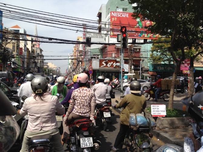 Zipping through the busy streets in Ho Chi Minh on Loc's motorcycle. Zipping through the busy streets in Ho Chi Minh on Loc's motorcycle.