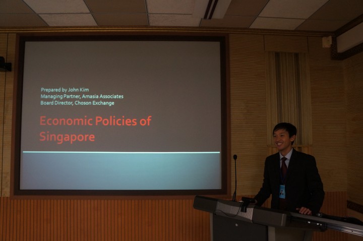 This is John Kim presenting about Singapore's economic policies.