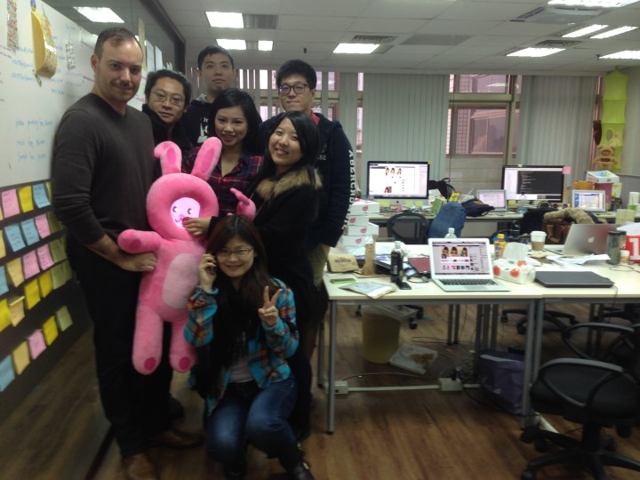 Jason Warren, left, holds TuTu with the Roam and Wander team at TMI in Taipei