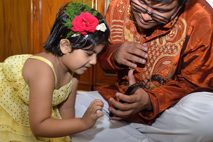 india kid touching smartphone