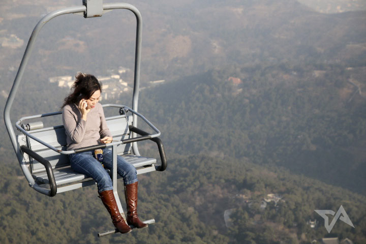 woman on phone chairlift