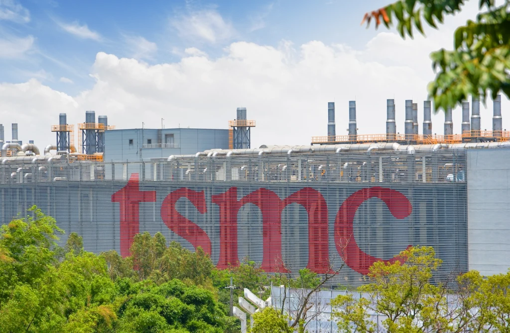 Taichung, Taiwan - 06 12 2021: tsmc sign in huge letters on a foundry in Taichung City with blue skies in the background and green trees in the foreground shot during summer