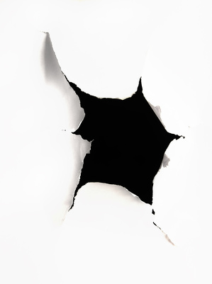 A hole torn in a peice of paper