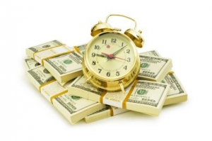 Time is money concept with dollars and clock