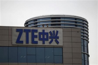 Employees of ZTE chat on the roof of its headquarters in Shenzhen, Guangdong province