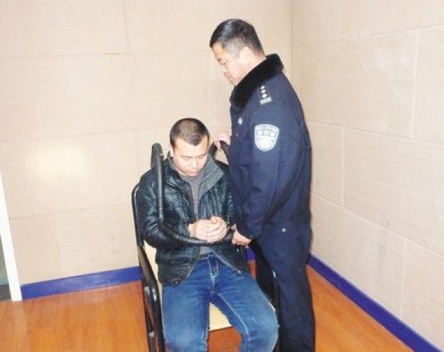 Xia in police custody.