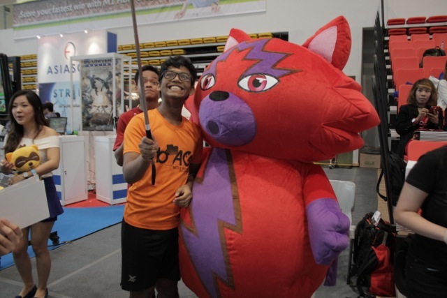A fan taking a selfie with Strife mascot Moxie.