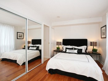 A big mirror makes this tiny bedroom feel bigger.