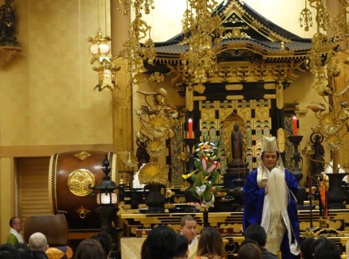 The Buddhist priest speaking to the crowd