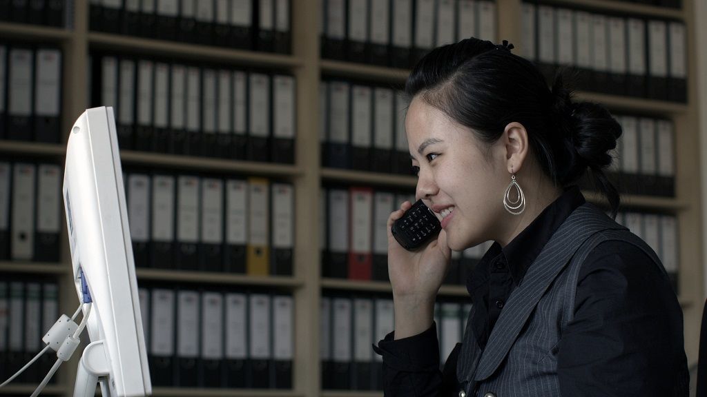 employee on the phone in front of computer screen