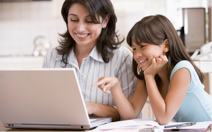 Mother and daughter looking at computer