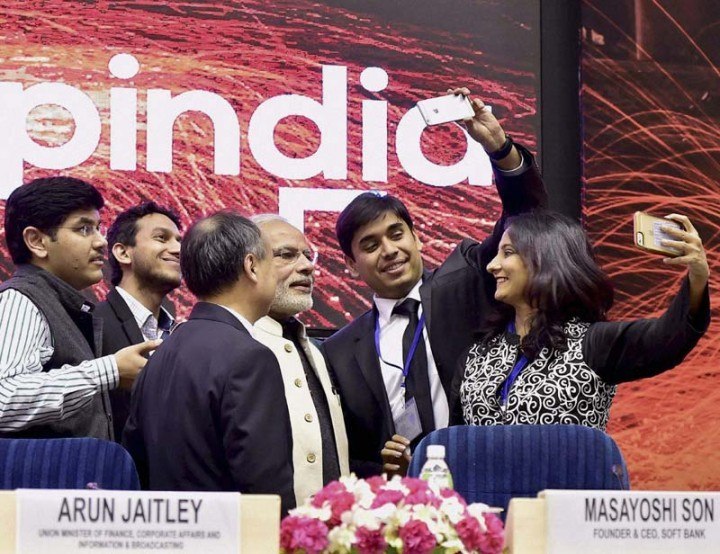 (Holding phones) MapMyGenome CEO Anu Acharya and InMobi CEO Naveen Tewari try to click a Selfie with Indian Prime Minister Narendra Modi at Startup India event in January, this year. Photo Credit: The Financial Express