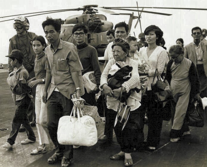 South Vietnamese refugees walk across a U.S. Navy vessel. Operation Frequent Wind began in April 29, 1975. Photo credit: Wikipedia