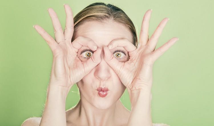 Woman with fingers for glasses