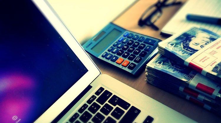 Financial planning - computer with calculator on table