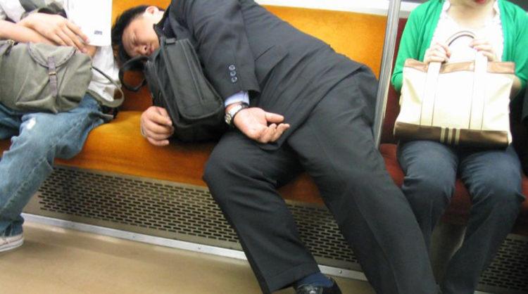 Japanese salaryman asleep on a train.
