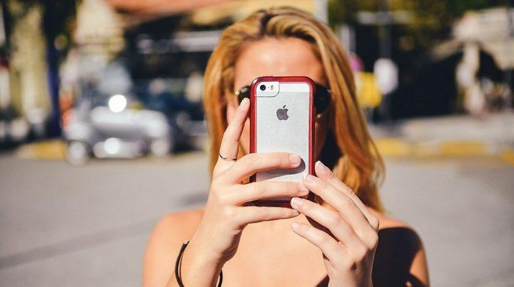 Girl holding up phone