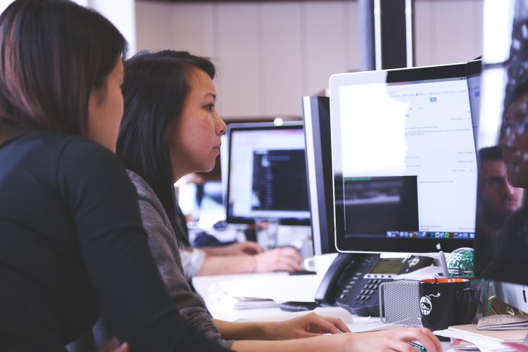 Two young women working. Photo credit: Pixabay