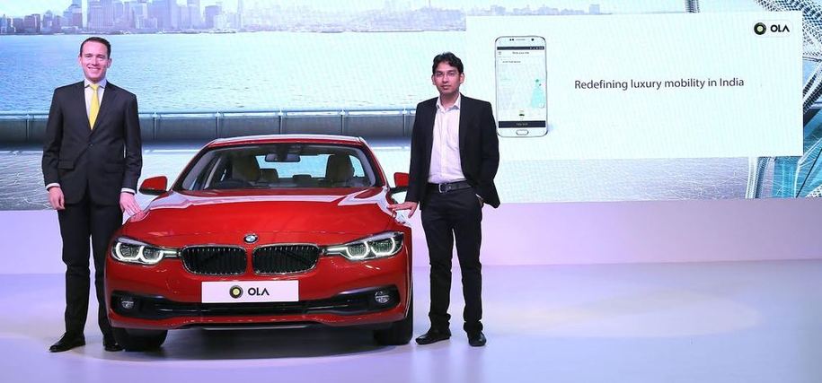 BMW India acting president Frank Schloeder (left), with Ola COO Pranay Jivrajka at the event to announce the partnership announcement 