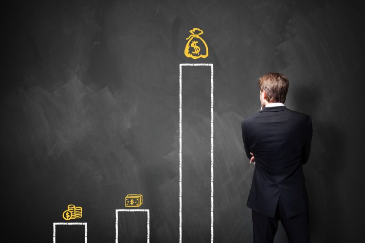 36899706 - businessman standing in front of a blackboard with a chart about different types of wages