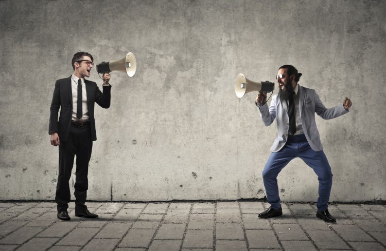 businessmen shouting through megaphones