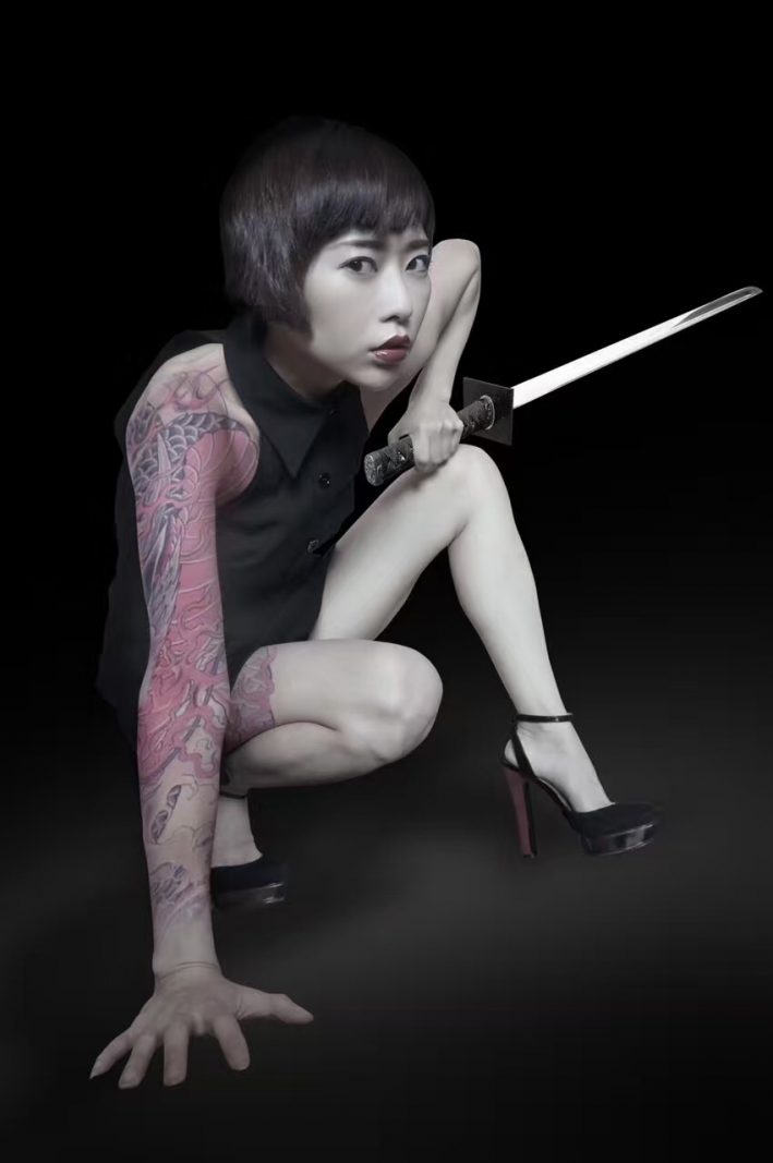 Yuanwu's husband loves photography and often helps her create content. He edited the tattoos and sword into this photo. Photo credit: Tan Yuanwu.