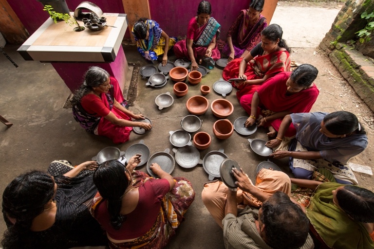 Women seasoning utensils. Photo credit: The VillageFair.