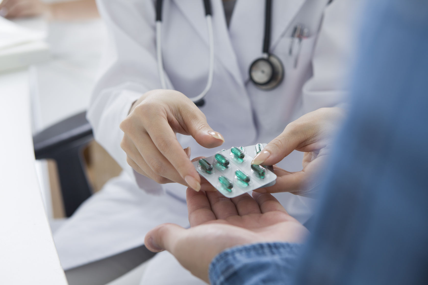 doctor taking woman's blood pressure