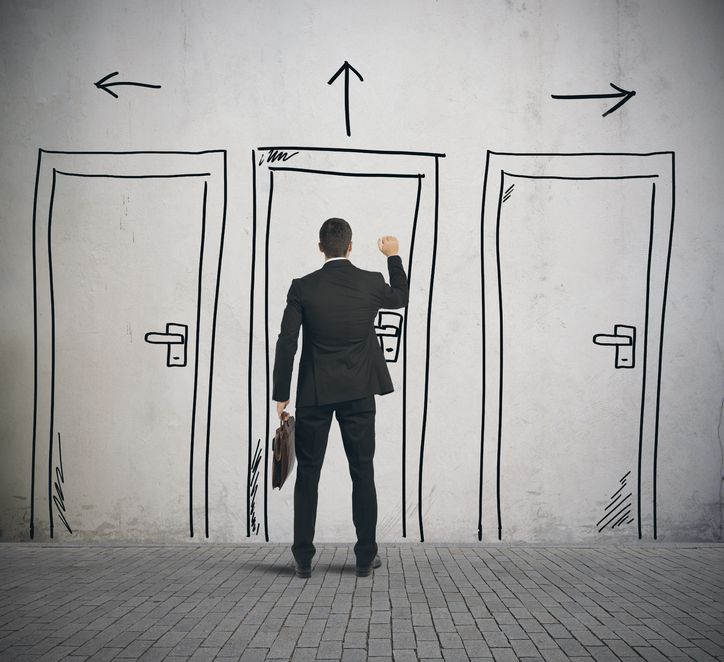 businessman opens a door designed in a wall