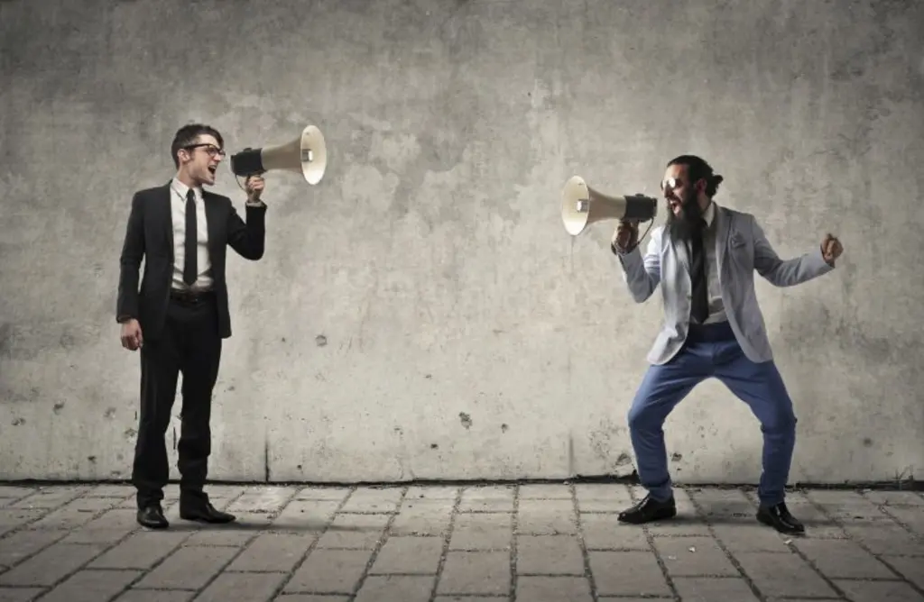 businessmen shouting through megaphones